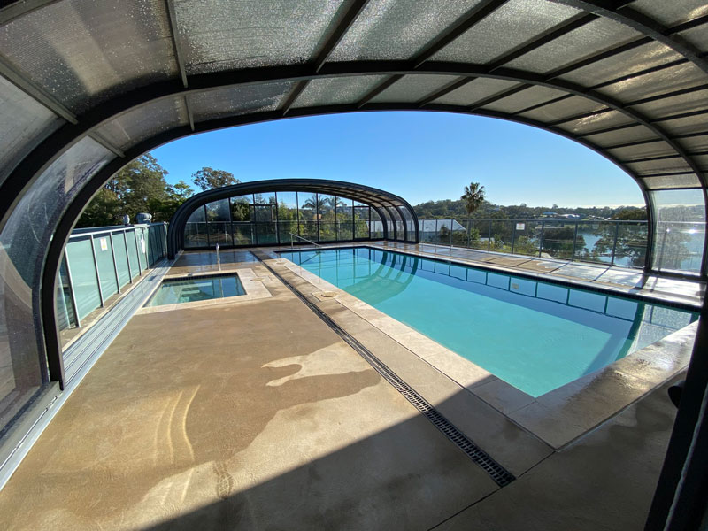 A retractable pool enclosure over a large pool and spa area