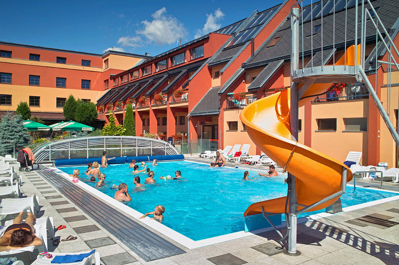 A commercial pool enclosure over a large resort pool