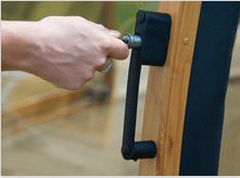 A lockable door handle on an angular pool enclosure frame