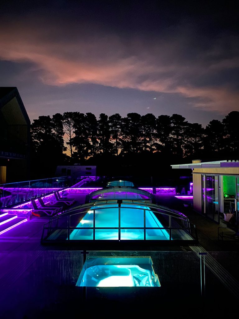 A Pool Enclosure In Tasmania Lit Up With Colourful Lighting